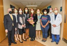 A group of masked people stand in the hallway of Jefferson Abington Hospital.