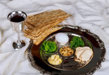 A silver seder plate displays the traditional Passover foods.