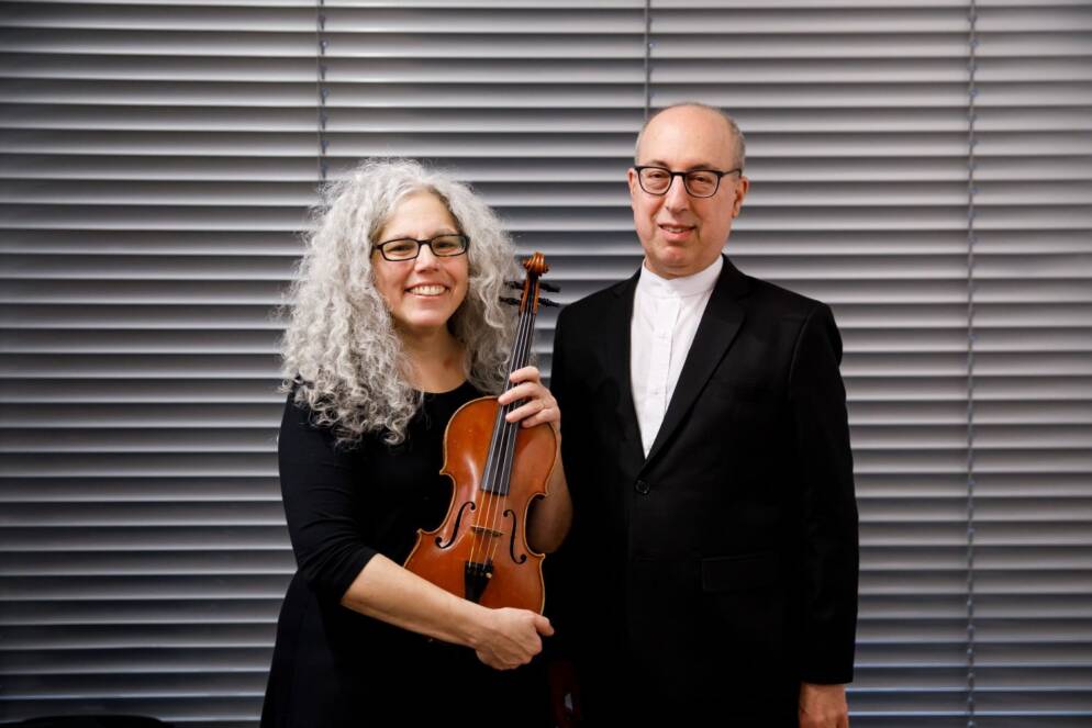 Two musicians in formal garb pose
