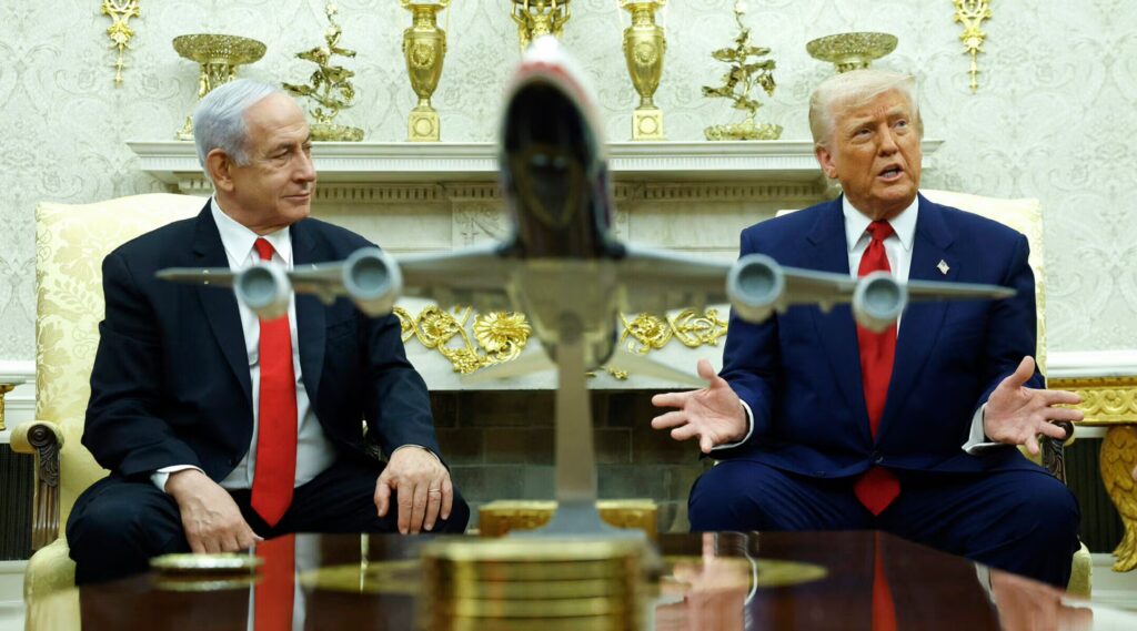 Two men sitting at a meeting