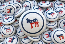 Many round plates with the logo of the Democratic Party of the United States of America. Concept of elections in the USA.