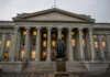 Trump Administration Sanctions Iranian Shadow Banking Sector A large, gray building with pillars.