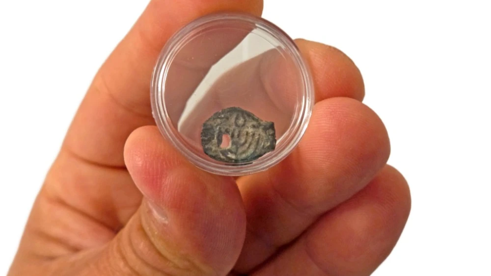 A rare Hasmonean-period coin depicting a seven-branched candelabrum that U.S. authorities returned to Israel following an investigation into antiquity theft.