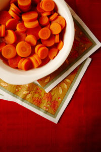 Bowl of sliced carrots on table