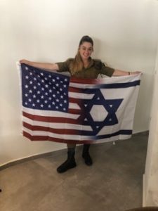 Elizabeth McNeill with a flag combining the American and Israeli flags