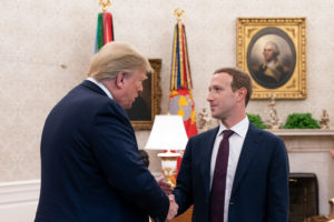 Donald Trump is shaking hands with Mark Zuckerberg in the Oval Office.