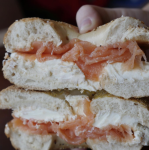 A picture of a bagel cross section, complete with a thick layer of cream cheese and lox 