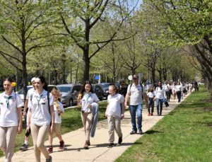 A group of people dressed in white walk together.