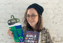 Hannah Lavon holding up a book she wrote and a pair of socks.