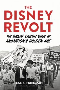 The title of the book is in bold red and black letters over a picture of strikers, one of whom is holding a sign with Donald Duck on it.