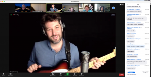 A Zoom screenshot shows Joey Weisenberg wearing headphones and playing a guitar for a virtual audience.