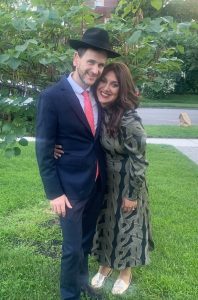 Binyomin and Gevura Davis stand outside, embracing.