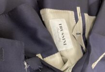 A navy suit jacket with its beige collar lining taken out