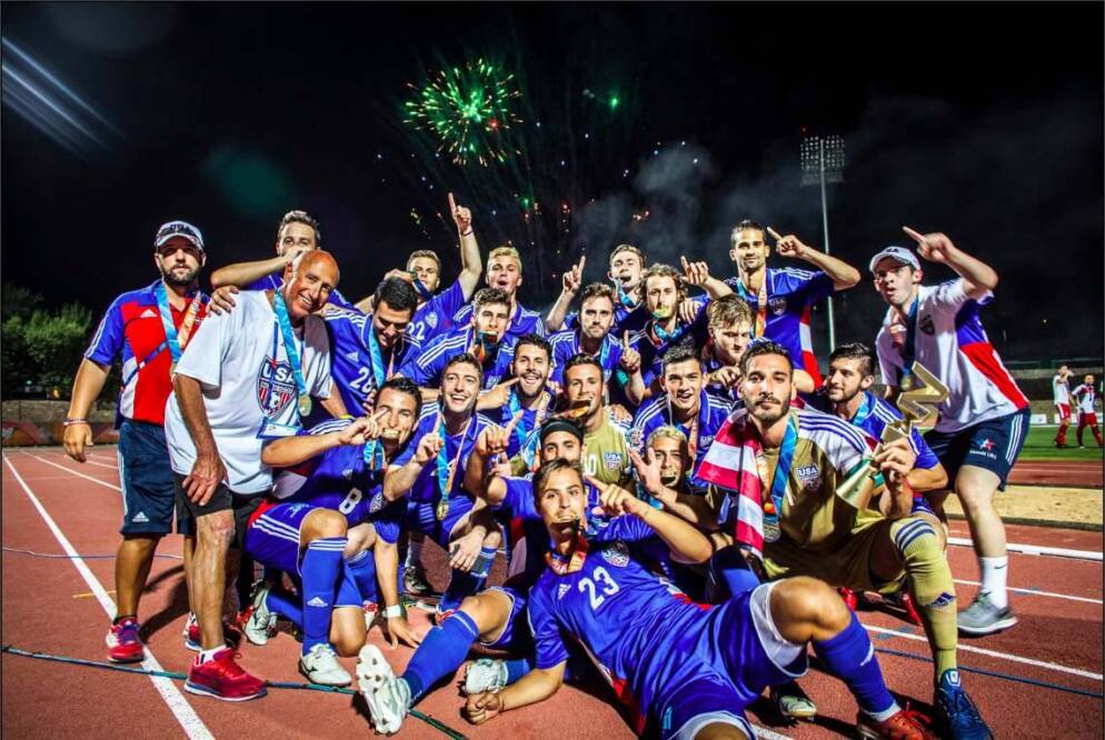 A team of athletes poses with their medals.