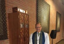 Families Juggle a Busy Jewish Fall A rabbi stands in front of an ark.