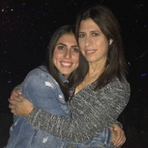 A mother and daughter smile