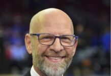 A man with a beard who is wearing a jacket and tie.