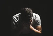 A man holding his head in his hands.