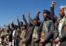 A group of men with their right arms raised.
