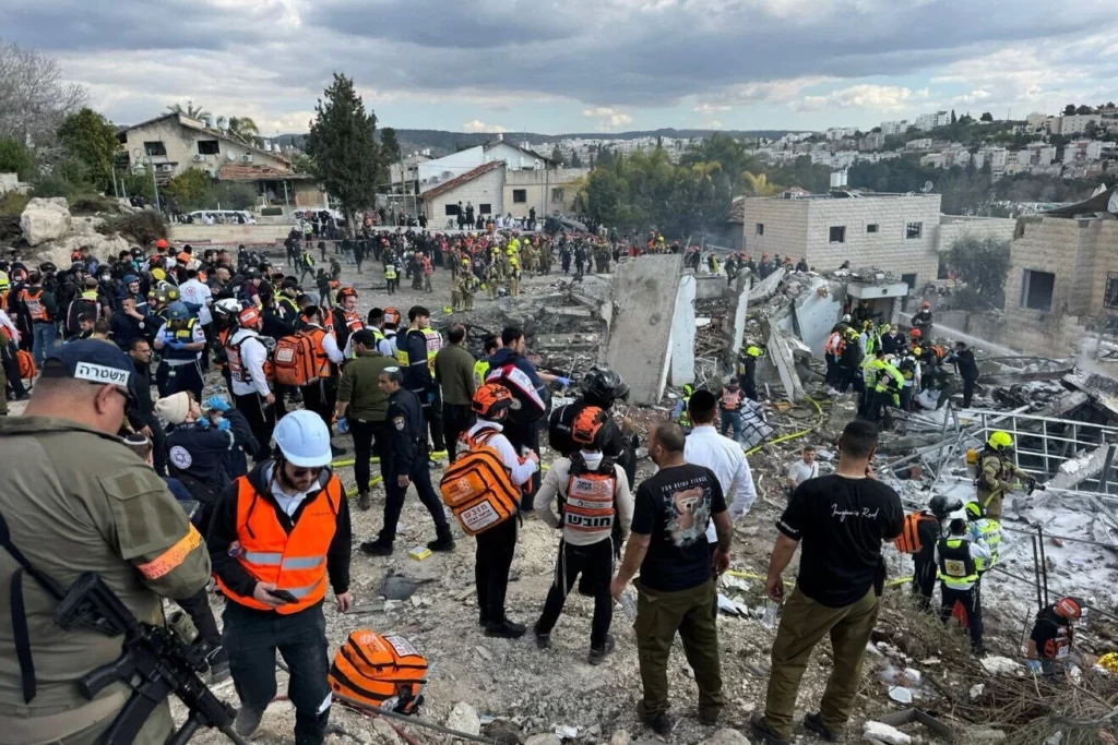 A group of first responders at the site of a missile strike.