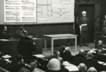 A black and white photo of an old courtroom scene.