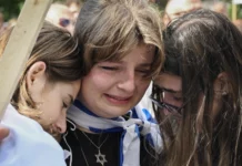People embrace as they attend a vigil outside McGill University in Montreal, Quebec, Canada on Oct., 7, 2024, to commemorate the victims of the Oct. 7 attack by Hamas on Israel.